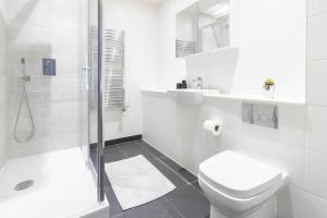 a white bathroom with a toilet and a shower at OPP Exeter LH11 - Behind the Cathedral with free parking! BIG SAVINGS booking 7 nights or more! in Exeter