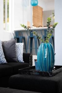 a blue vase sitting on a table in a living room at Azure Belle Caye in Gros Islet