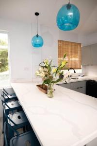 a kitchen with a counter with a vase of flowers on it at Azure Belle Caye in Gros Islet