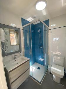 a bathroom with a shower and a sink and a toilet at Apartamentos Currás en Touriñán in Touriñán