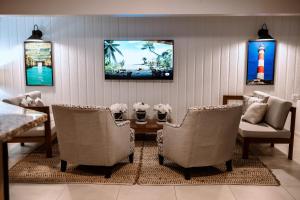 a living room with a table and chairs at Pirate's Inn in Bridgetown