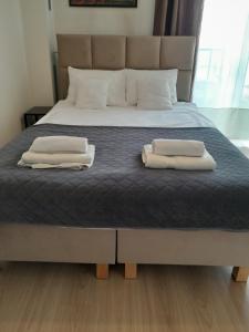 Posteľ alebo postele v izbe v ubytovaní Królewski Apartament