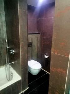 a bathroom with a toilet in a bathroom stall at Hotel Svm Pride Banjara-Hot Live Counter-Road View Stay- Free Lavish Buffet Breakfast-18 Percent Off In Restaurant Food Order in Hyderabad