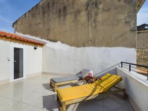 a yellow bench on the roof of a house at Pic love, 2 personnes jacuzzi in Châteaurenard