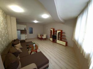 a living room with a couch and a table at Lux Apartment Sisi in Burgas