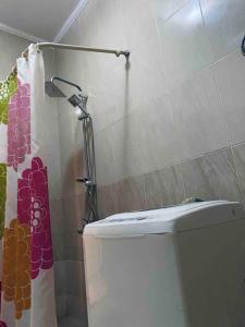 a bathroom with a toilet and a shower curtain at Classy and Relaxy apartment in 6 October city Cairo Egypt in 6th Of October