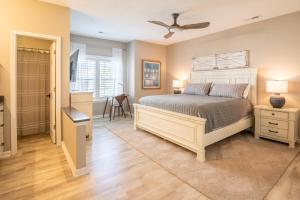 a bedroom with a bed and a walk in shower at Stunning Magnolia Greens Golf Resort Condo in Leland
