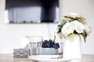 a vase with flowers and a plate and a glass at The Shoreditch Creative Studio in London