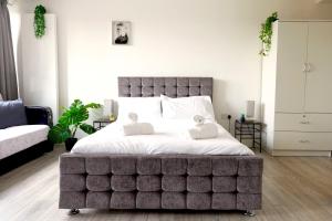 a large bedroom with a large bed with white sheets at The Shoreditch Creative Studio in London