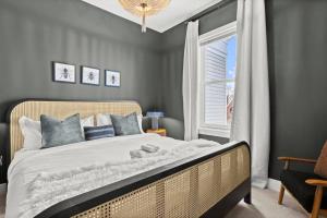 a bedroom with a large bed and a window at An Alluringly Cozy Suite Xcape in Alexandria