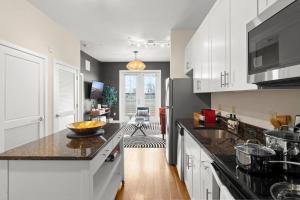 a kitchen with white cabinets and a counter top at An Alluringly Cozy Suite Xcape in Alexandria