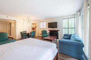 a bedroom with a bed and a living room at Le Bordeau à Saint-Sauveur in Saint-Sauveur-des-Monts