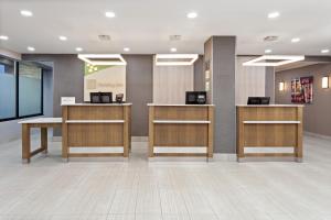 a lobby of a hospital with wooden reception desks at Holiday Inn Chicago/Oak Brook, an IHG Hotel in Oakbrook Terrace