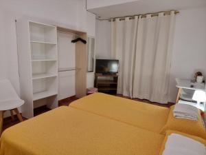 Postel nebo postele na pokoji v ubytování Casa de Huéspedes Cuenca