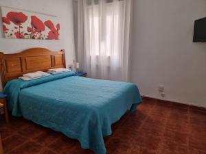 Postel nebo postele na pokoji v ubytování Casa de Huéspedes Cuenca