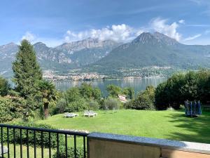 a balcony with a view of a lake and mountains at Villa Oliveto apartments in Oliveto Lario