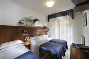 A bed or beds in a room at Hotel Vina De Mar