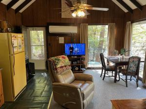 a living room with a couch and a table with a television at River Rhapsody in Sevierville