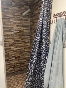 a bathroom with two blue and white towels and a wall at Choza Azahares in Santiponce +26 photos