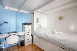 a bedroom with a bed and a desk and a chair at Loft studio in the heart of Paris - Welkeys in Paris