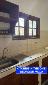 a kitchen with a kitchen in the one bedroom villa at Villa Lombok Senggigi Kamila Forest By Villaloka in Mangsit