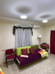 a living room with a couch and a chair at Cozy apartment in the center of Novi Sad! in Novi Sad