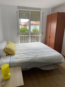 a bedroom with a large bed and a window at Choza Azahares in Santiponce