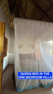 a bed with a sign that reads queen bed in the one bedroom villa at Villa Lombok Senggigi Kamila Forest By Villaloka in Mangsit