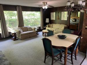 a living room with a table and chairs at Riversong in Sevierville