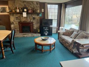 a living room with a couch and a fireplace at Riversong in Sevierville