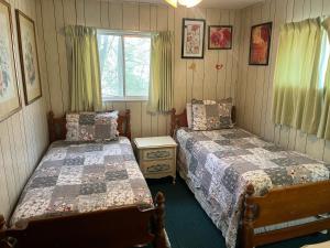 a bedroom with two beds and a window at Riversong in Sevierville