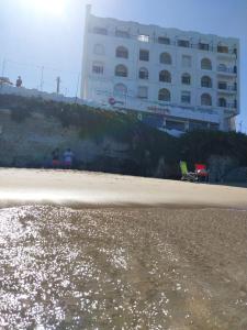 a beach with a large building in the background at Mirador Azul Apart, 3 A,B,C in Las Grutas