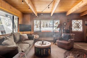 a living room with a couch and a coffee table at Quaint Cabin in Serene Lakes - Close to Skiing! in Soda Springs