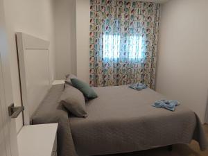 1 dormitorio con 1 cama con cortina y ventana en Mojacar Luxury en Mojácar