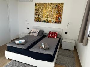 a bedroom with a bed with two pillows on it at Villalvento in Brenzone sul Garda +61 photos