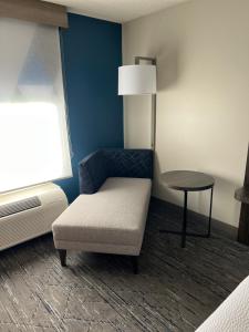 a living room with a chair and a table at Holiday Inn Express Birmingham Irondale East, an IHG Hotel in Birmingham