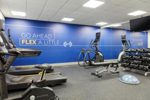 a gym with cardio equipment and a blue wall at Holiday Inn Express Peachtree Corners-Norcross, an IHG Hotel in Norcross