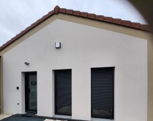 a white building with two windows and a red roof at THE BEDROOM - proche aeroport Lyon, groupama stadium, ldlc arena, eurexpo, viaRhôna in Jonage