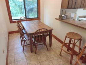 a kitchen with a wooden table and four chairs at The Hideaway in Sevierville +4 photos