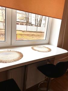a desk with a chair in front of a window at Struve Apartment City Centre in Tartu