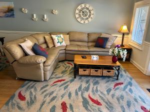 a living room with a couch and a coffee table at Unique 3BR, 1 of 5 Condos w/Huge Poolside Patio, Steps to Beach & Pier, Gated in Tybee Island