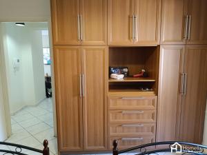 a large wooden cabinet with drawers in a kitchen at Spacious 2bedroom apartment in Chalkida
