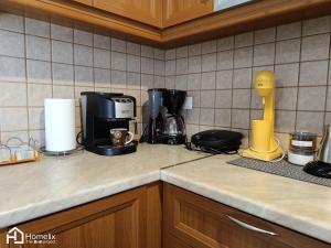a kitchen counter top with a coffee maker on it at Spacious 2bedroom apartment in Chalkida