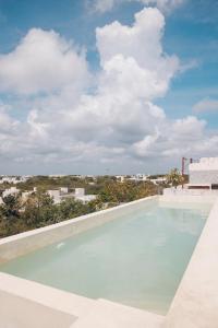 a swimming pool with a view of the city at 2 FREE BICYCLES BEAUTIFUL SUIT NEAR THE SEA BEAUTIFUL POOl in Tulum
