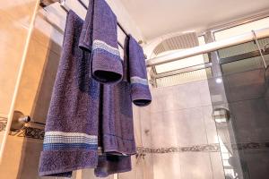 uma toalha roxa está pendurada numa casa de banho em AP NA BELA VISTA, PRÓXIMO AO BEXIGA, STUDIO PRIVATIVO E COMPLETO em São Paulo mais 23 fotografias