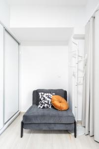 a blue couch in a room with windows at Velvet Luxury Studios in the City Center by BiNoBi! in Thessaloniki