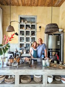 a man and woman standing behind a kitchen counter at SAMAMBAIA in Rio de Janeiro