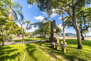 park z ławkami w trawie w pobliżu plaży w obiekcie Apartamento a 140 metros da Praia de Santos w mieście Santos