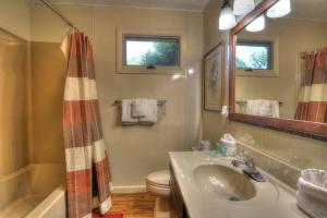 a bathroom with a sink and a toilet and a mirror at Cap's Fishin' Camp #542 in Sevierville +23 photos