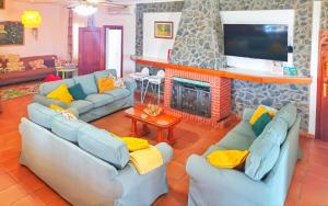 a living room with blue couches and a fireplace at El Olmo in Posadas